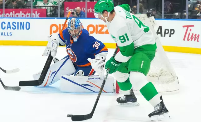 Toronto Maple Leafs' John Tavares (91) shoots on New York Islanders goaltender Ilya Sorokin (30) during second period NHL hockey action in Toronto, on Tuesday March 17, 2026. (Chris Young/The Canadian Press via AP)