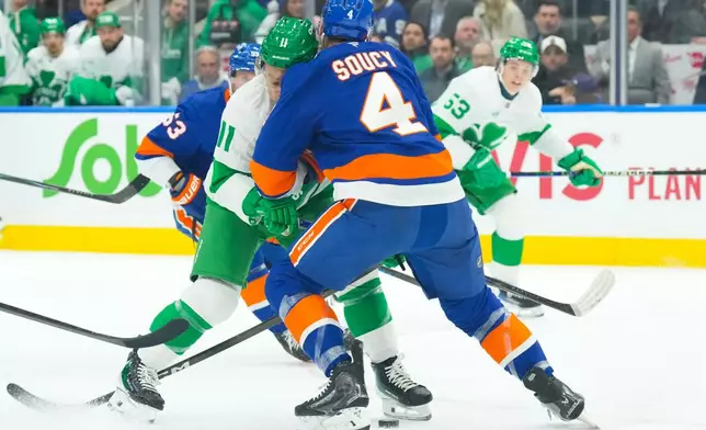 Toronto Maple Leafs' Max Domi (11) runs into New York Islanders' Carson Soucy (4) during second period NHL hockey action in Toronto, on Tuesday March 17, 2026. (Chris Young/The Canadian Press via AP)