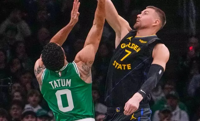 Golden State Warriors center Kristaps Porzingis (7) blocks a shot by Boston Celtics forward Jayson Tatum (0) during the first half of an NBA basketball game, Wednesday, March 18, 2026, in Boston. (AP Photo/Charles Krupa)
