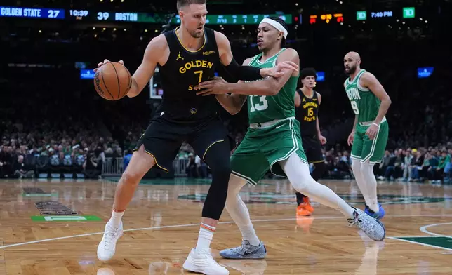 Golden State Warriors center Kristaps Porzingis (7) drives to the basket against Boston Celtics guard Ron Harper Jr. (13) during the first half of an NBA basketball game, Wednesday, March 18, 2026, in Boston. (AP Photo/Charles Krupa)