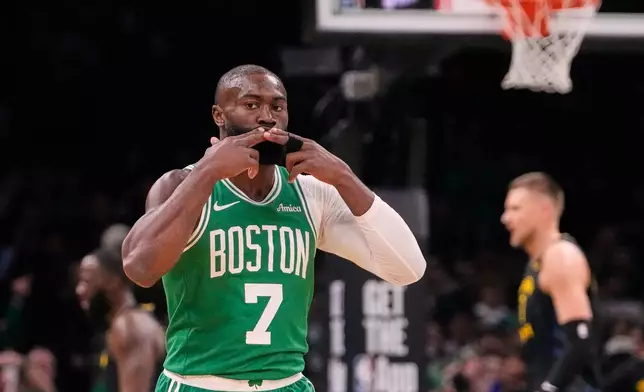 Boston Celtics guard Jaylen Brown (7) blows a kiss to fans after hitting a 3-pointer against the Golden State Warriors during the first half of an NBA basketball game, Wednesday, March 18, 2026, in Boston. (AP Photo/Charles Krupa)