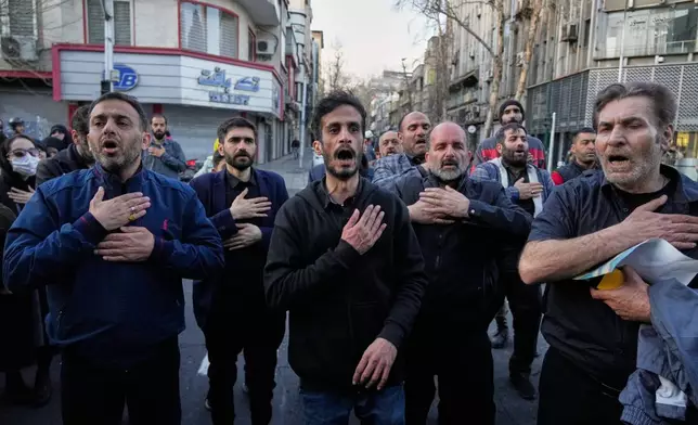 A group of men beat their chests as a sign of grief and mourning near the residency of the late Iranian Supreme Leader Ayatollah Ali Khamenei in Tehran, Iran, Sunday, March 1, 2026, in the aftermath of his confirmed death in U.S. and Israeli strikes. (AP Photo/Vahid Salemi)