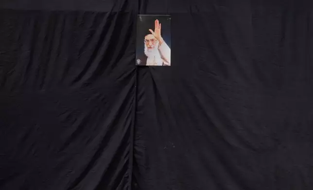A picture of the late Iranian Supreme Leader Ayatollah Ali Khamenei hangs on a black sheet along the side of a mosque in Tehran, Iran, Monday, March 2, 2026. (AP Photo/Vahid Salemi)