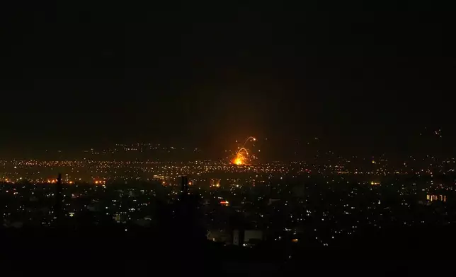 An explosion is seen in Tehran, Iran, Sunday, March 1, 2026. (AP Photo/Vahid Salemi)