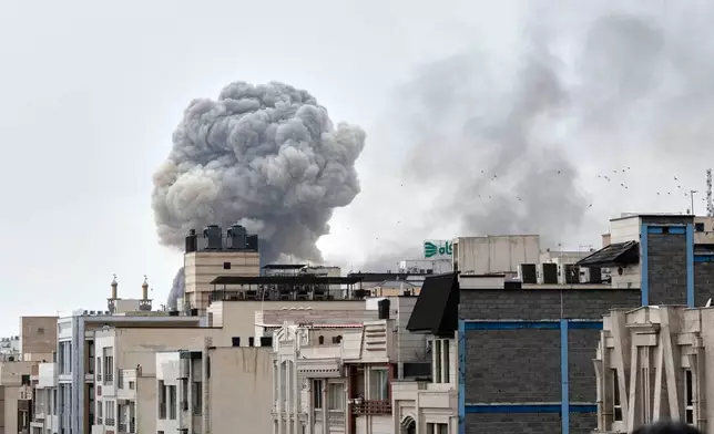 A plume of smoke rises after a strike in Tehran, Iran, Monday, March 2, 2026. (AP Photo/Vahid Salemi)