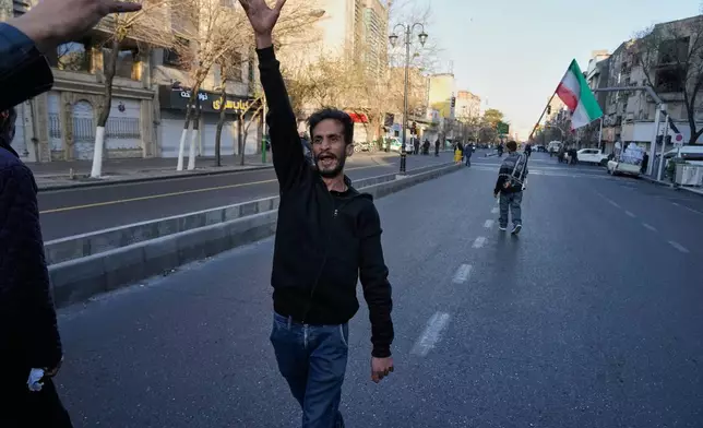 A man shouts slogans as he walks ahead of a group of government supporters marching in support of the late Iranian Supreme Leader Ayatollah Ali Khamenei in Tehran, Iran, Sunday, March 1, 2026, in the aftermath of his confirmed death in U.S. and Israeli strikes. (AP Photo/Vahid Salemi)