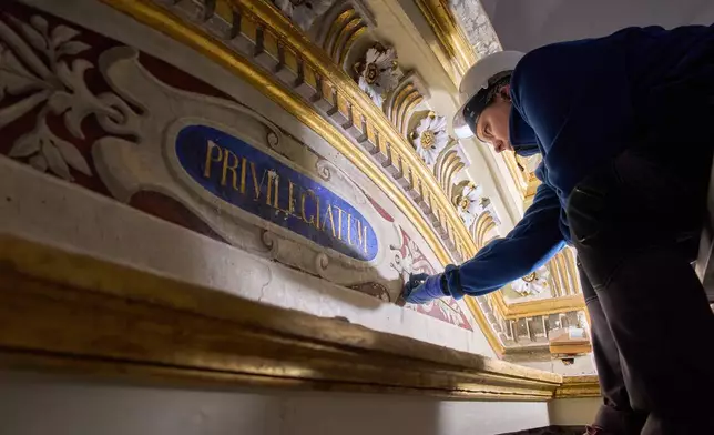 Restorer Domiziana Marchioro polishes the altar od St. Sebastian inside the Basilica of San Pietro in Vincoli in Rome, Monday, March 9, 2026. (AP Photo/Domenico Stinellis)
