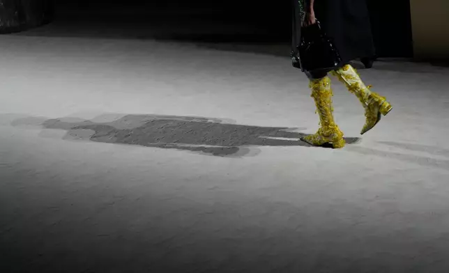 A model wears a creation from the Prada Fall/Winter 2026-2027 Women's collection presented in Milan, Italy, Thursday, Feb. 26, 2026. (AP Photo/Luca Bruno)