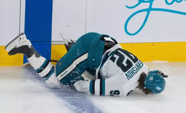San Jose Sharks' Igor Chernyshov (92) lies on the ice after being checked by Montreal Canadiens' Mike Matheson (not shown) during the first period of an NHL hockey game in Montreal, Saturday, March 14, 2026. (Christinne Muschi/The Canadian Press via AP)