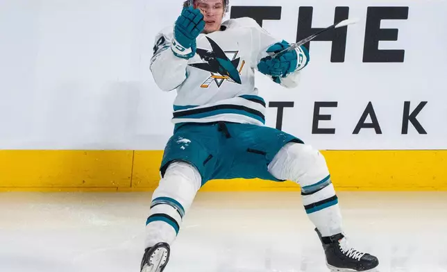 San Jose Sharks' Igor Chernyshov (92) falls to the ice as he tries to stand following being checked by Montreal Canadiens' Mike Matheson (not shown) during the first period of an NHL hockey game in Montreal, Saturday, March 14, 2026. (Christinne Muschi/The Canadian Press via AP)