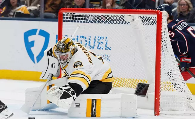 Boston Bruins' Jeremy Swayman makes a save against the Columbus Blue Jackets during the first period of an NHL hockey game, Sunday, March 29, 2026, in Columbus, Ohio. (AP Photo/Jay LaPrete)