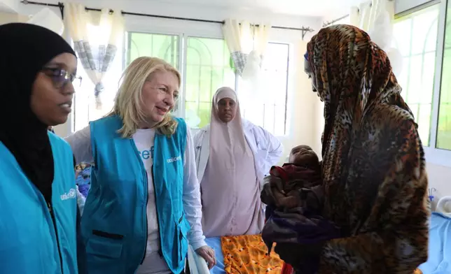 UNICEF Executive Director Catherine Russell (center) listens to a woman holding her malnourished child at Dolow Referral Hospital in southern Somalia after being affected by drought, Wednesday, March 25, 2026. (AP Photo/Mohamed Sheikh Nor)