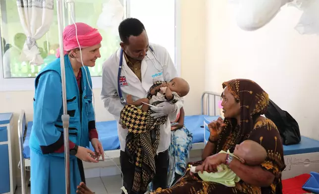 Sandra Lattouf, UNICEF Representative in Somalia, smiles at a mother of twin malnourished children at Dolow Referral Hospital in southern Somalia, Wednesday, March 25, 2026.(AP Photo/Mohamed Sheikh Nor)
