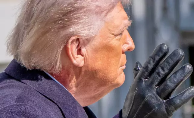 Redness is visible on the neck of President Donald Trump waves as he walks to depart on Marine One from the South Lawn of the White House, Friday, Feb. 27, 2026, in Washington. (AP Photo/Alex Brandon)