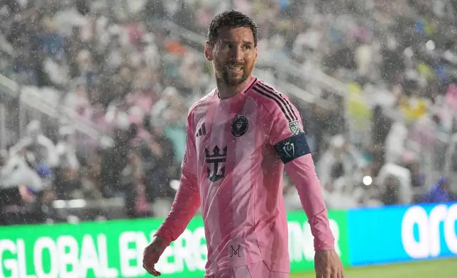 Inter Miami forward Lionel Messi (10) walks to kick a corner kick in heavy rain during the first half of a CONCACAF Champions Cup Round of 16 soccer match against Nashville, Wednesday, March 18, 2026, in Fort Lauderdale, Fla. (AP Photo/Marta Lavandier)