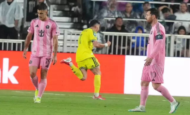 Inter Miami forwards Germán Berterame (19) and Lionel Messi (10) react as Nashville forward Cristian Espinoza (7) celebrates his goal during the second half of a CONCACAF Champions Cup Round of 16 soccer match, Wednesday, March 18, 2026, in Fort Lauderdale, Fla. (AP Photo/Marta Lavandier)