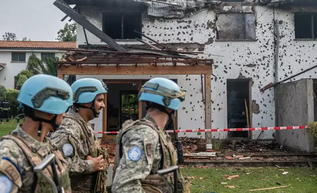 U.N peacekeepers guard a house hit by a drone strike in Goma, Democratic Republic of Congo, Wednesday, March 11, 2026. (AP Photo/Moses Sawasawa)