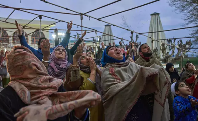 Muslim devotees pray as the head priest displays a holy relic believed to be a hair from the beard of the Prophet Muhammad during special prayers to observe the martyr day of Hazrat Ali, the fourth caliph of Islam, at Hazratbal shrine in Srinagar, Indian controlled Kashmir, Wednesday, March 11, 2026. (AP Photo/Dar Yasin)