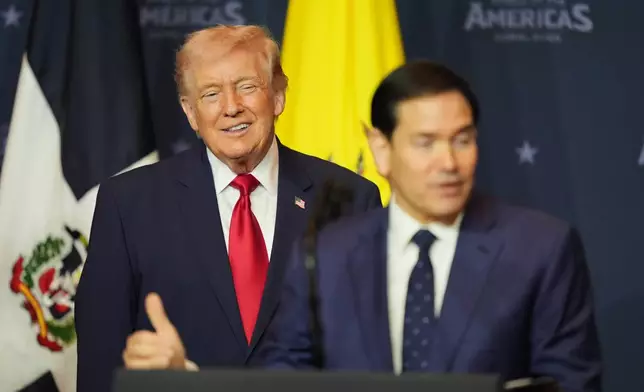 President Donald Trump listens while Secretary of State Marco Rubio speaks at the Shield of the Americas Summit, Saturday, March 7, 2026, at Trump National Doral Miami in Doral, Fla. (AP Photo/Rebecca Blackwell)
