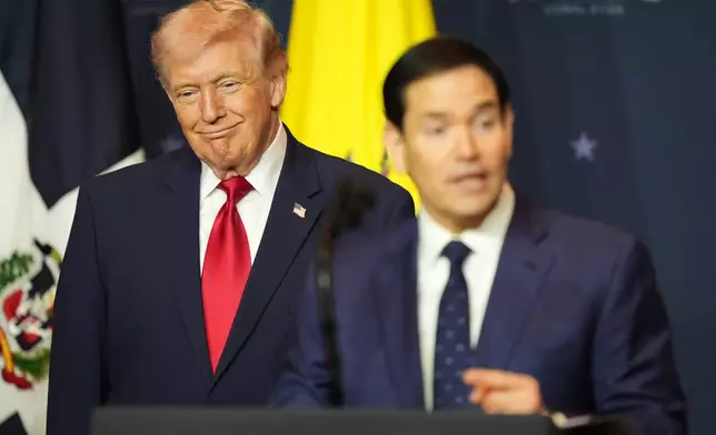 President Donald Trump listens while Secretary of State Marco Rubio speaks at the Shield of the Americas Summit, Saturday, March 7, 2026, at Trump National Doral Miami in Doral, Fla. (AP Photo/Rebecca Blackwell)