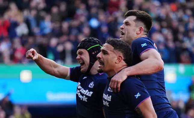 Scotland's Darcy Graham, left, celebrates scoring a try during the Six Nations rugby match between Scotland and France in Edinburgh, Scotland, Saturday March 7, 2026. (Jane Barlow/PA via AP)