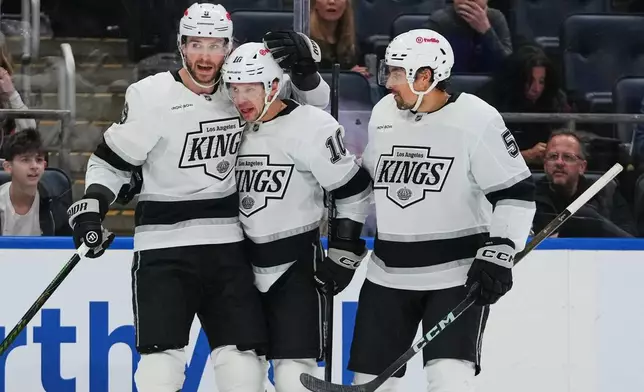 Los Angeles Kings' Adrian Kempe (9), Artemi Panarin (10) and Cody Ceci (5) celebrate after Kempe scored a goal during the first period of an NHL hockey game against the New York Islanders Friday, March 13, 2026, at UBS Arena in Elmont, N.Y. (AP Photo/Frank Franklin II)