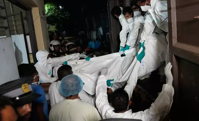 Healthcare workers unload the bodies of Iranian sailors from a vehicle who died when their IRIS Dena warship sank outside Sri Lanka's territorial waters, in Galle, Sri Lanka, Wednesday, March 4, 2026. (AP Photo/Eranga Jayawardena)