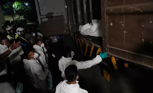 Healthcare workers unload the bodies of Iranian sailors from a vehicle who died when their IRIS Dena warship sank outside Sri Lanka's territorial waters, in Galle, Sri Lanka, Wednesday, March 4, 2026. (AP Photo/Eranga Jayawardena)