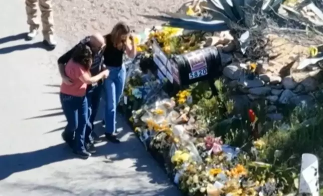 This image made from video provided by FOX News Digital shows Savannah Guthrie, right, her sister Annie Guthrie, left, and her brother-in-law Tommaso Cioni, Monday, March 2, 2026, visiting a tribute to their mother Nancy Guthrie. (FOX News Digital via AP)