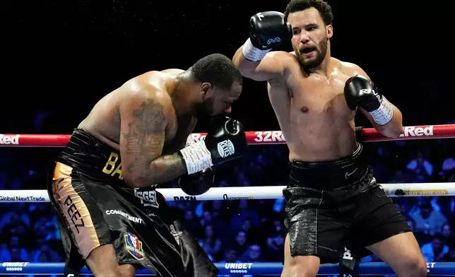 Moses Itauma, right, attempts to land a punch on Jermaine Franklin during a WBA International and WBO Inter-Continental Heavyweight bout against Jermaine Franklin, Saturday, March 28, 2026, in Manchester, England. (Nick Potts/PA via AP)