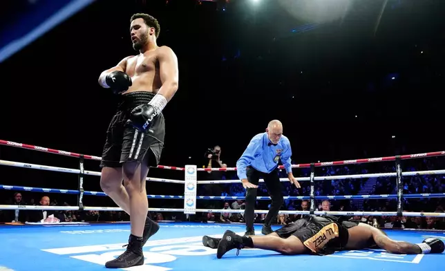 Moses Itauma left, reacts after knocking down Jermaine Franklin during a WBA International and WBO Inter-Continental Heavyweight bout against Jermaine Franklin, Saturday, March 28, 2026, in Manchester, England. (Nick Potts/PA via AP)