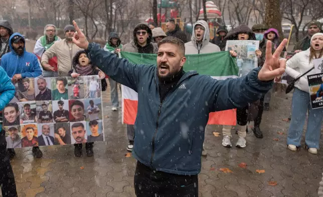 Iranian people attend a demonstration in support of the U.S. and Israeli strikes on Iran in front of Iranian Embassy in Yerevan, Armenia, Saturday, Feb. 28, 2026. (AP Photo/Anthony Pizzoferrato)