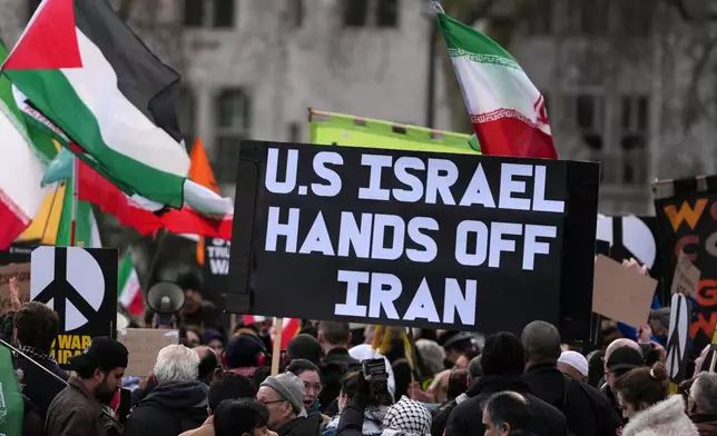 Protesters gather in London, Saturday, Feb. 28, 2026 after U.S. and Israeli forces carried out a series of strikes on Iran on Saturday morning. (AP Photo/Alastair Grant)
