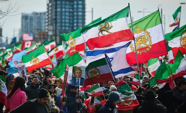 Protesters march in support of regime change in Iran during a demonstration in Richmond Hill, Ont., Saturday, Feb. 28, 2026. (Sammy Kogan/The Canadian Press via AP)