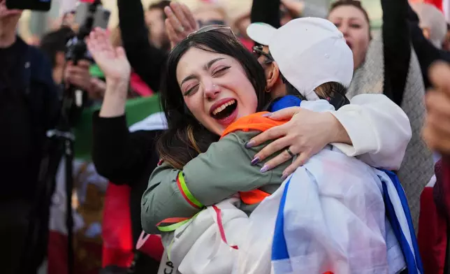 Iranian people attend a demonstration in support of the U.S. and Israeli strikes on Iran, in Berlin, Germany, Saturday, Feb. 28, 2026. (AP Photo/Markus Schreiber)
