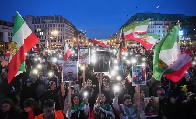 People attend a demonstration in support of the U.S. and Israeli strikes on Iran, in front of the U.S. Embassy in Berlin, Germany, Saturday, Feb. 28, 2026. (AP Photo/Markus Schreiber)