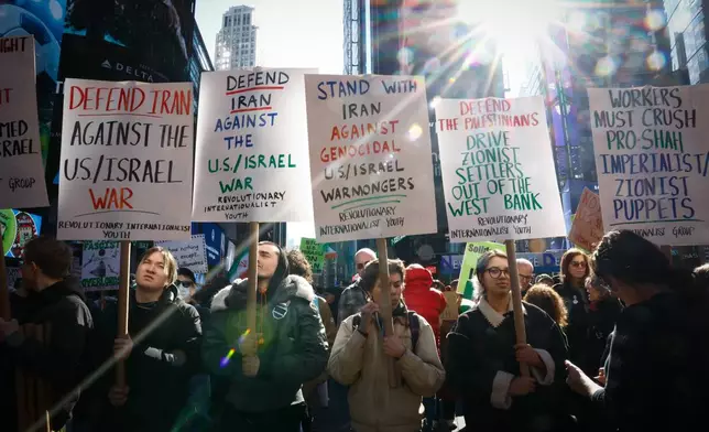 People protest against U.S. and Israeli strikes on Iran, in New York, Saturday, Feb. 28, 2026. (AP Photo/Kena Betancur)
