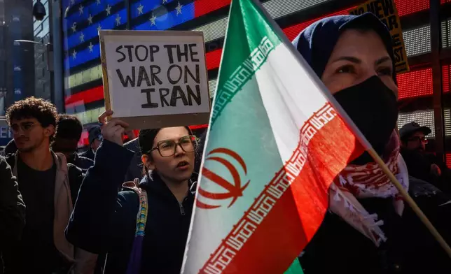 People protest against U.S. and Israeli strikes on Iran, in New York, Saturday, Feb. 28, 2026. (AP Photo/Kena Betancur)