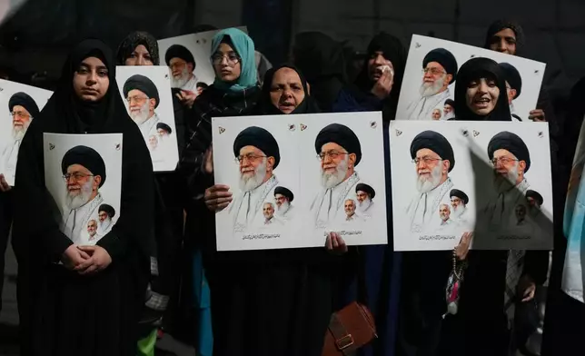 Shiite Muslims hold placards and chant slogans during a protest against the U.S. and Israel, and to show solidarity with Iran, in Lahore, Pakistan, Saturday, Feb. 28, 2026. (AP Photo/K.M. Chaudary)