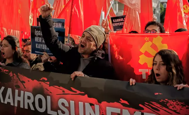 People chant slogans as they protest against U.S. and Israeli strikes on Iran, outside a NATO base in Izmir, Turkey, Saturday, Feb. 28, 2026. (AP Photo/Murat Kocabas)