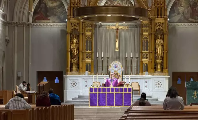 A Roman Catholic priest says a prayer during an afternoon Mass at the Cathedral of Saints Peter and Paul, which serves as the home church of the Roman Catholic Diocese of Providence, on Thursday, March 5, 2026, in Providence, R.I. (AP Photo/Rodrique Ngowi)
