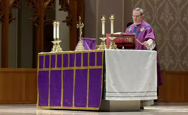 A Roman Catholic priest says a prayer during an afternoon Mass at the Cathedral of Saints Peter and Paul, which serves as the home church of the Roman Catholic Diocese of Providence, on Thursday, March 5, 2026, in Providence, R.I. (AP Photo/Rodrique Ngowi)