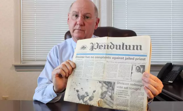 Dr. Herbert "Hub" Brennan, a clergy abuse survivor, displays a 1995 newspaper showing a headline that reads "Diocese has no complaints about jailed priest" at his internal medicine office in East Greenwich, R.I., Thursday, March 5, 2026. (AP Photo/Leah Willingham)