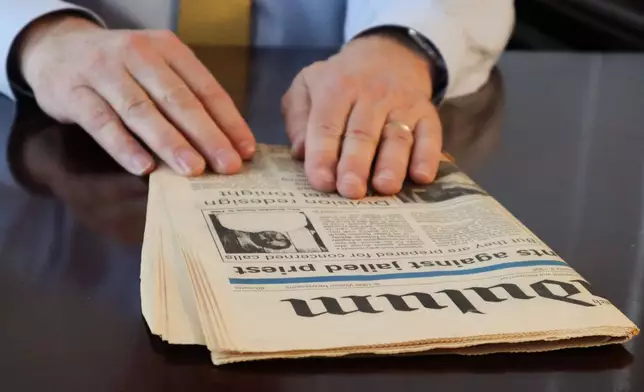 Dr. Herbert "Hub" Brennan, a clergy abuse survivor, shows at a 1995 newspaper article about the arrest of the Rev. Brendan Smyth while at his internal medicine office in East Greenwich, R.I., Thursday, March 5, 2026. (AP Photo/Leah Willingham)