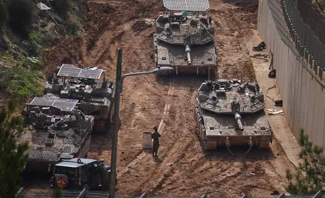 Israeli tanks maneuver near the Israel-Lebanon border, in northern Israel, Wednesday, March 4, 2026. (AP Photo/Ariel Schalit)