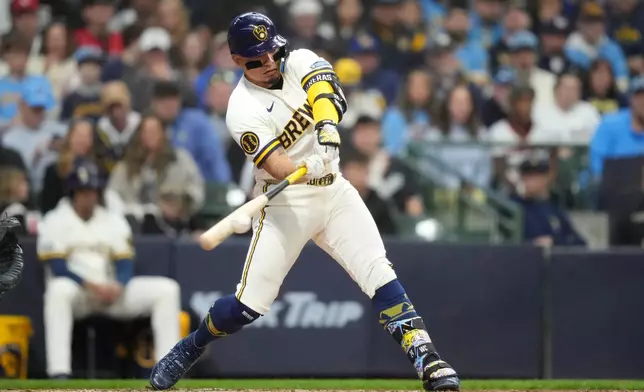 Milwaukee Brewers' William Contreras hits a three-run double during the second inning of an opening-day baseball game against the Chicago White Sox, Thursday, March 26, 2026, in Milwaukee. (AP Photo/Kayla Wolf)