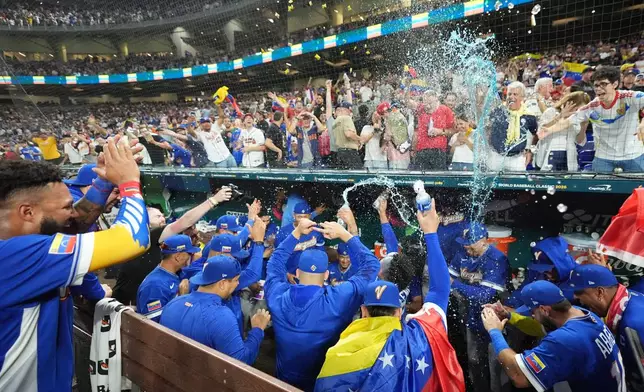 The Venezuela team celebrates after defeating Italy at a World Baseball Classic semifinal game, Monday, March 16, 2026, in Miami. (AP Photo/Rebecca Blackwell)