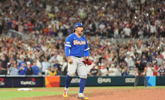 Venezuela pitcher Daniel Palencia celebrates after the team defeated the United States in the championship game of the World Baseball Classic, Tuesday, March 17, 2026, in Miami. (AP Photo/Rebecca Blackwell)