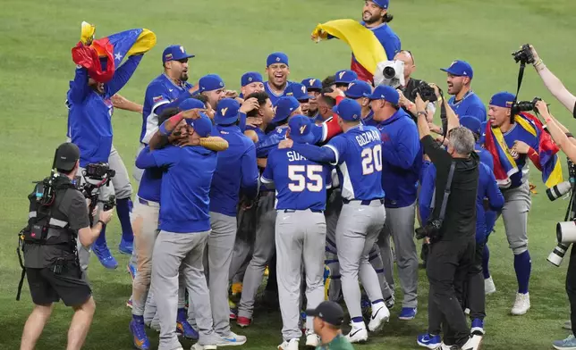 Venezuela celebrates after defeating the United States in the championship game of the World Baseball Classic, Tuesday, March 17, 2026, in Miami. (AP Photo/Lynne Sladky)
