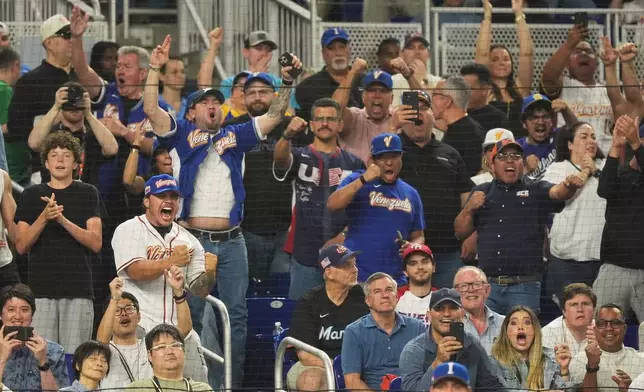 Venezuela fans cheer the team during the sixth inning of a World Baseball Classic semifinal game against Italy, Monday, March 16, 2026, in Miami. (AP Photo/Rebecca Blackwell)